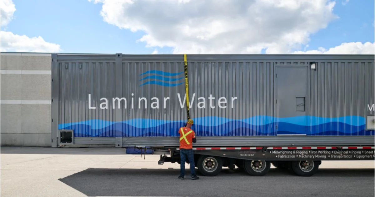 Worker securing Laminar Water mobile treatment container